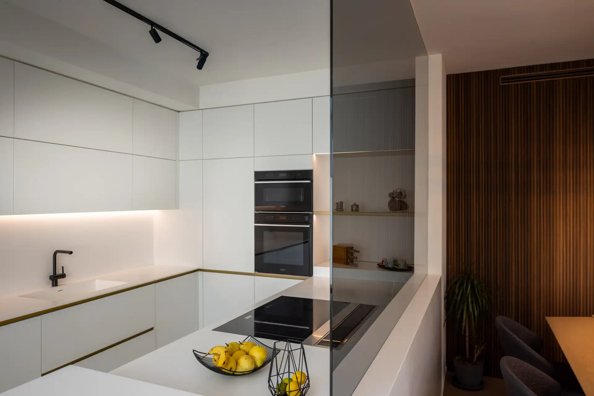 Handleless kitchen in white lacquer and warm timber