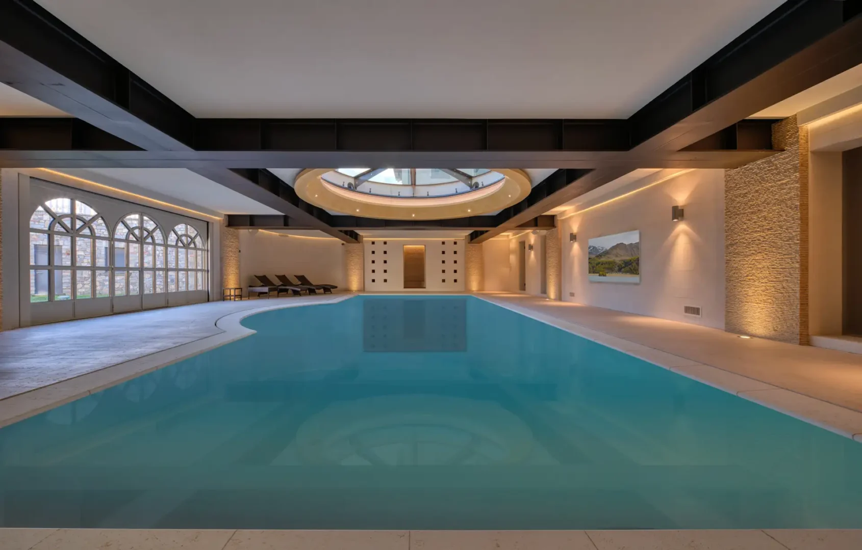 Indoor pool beneath a vaulted, skylit ceiling