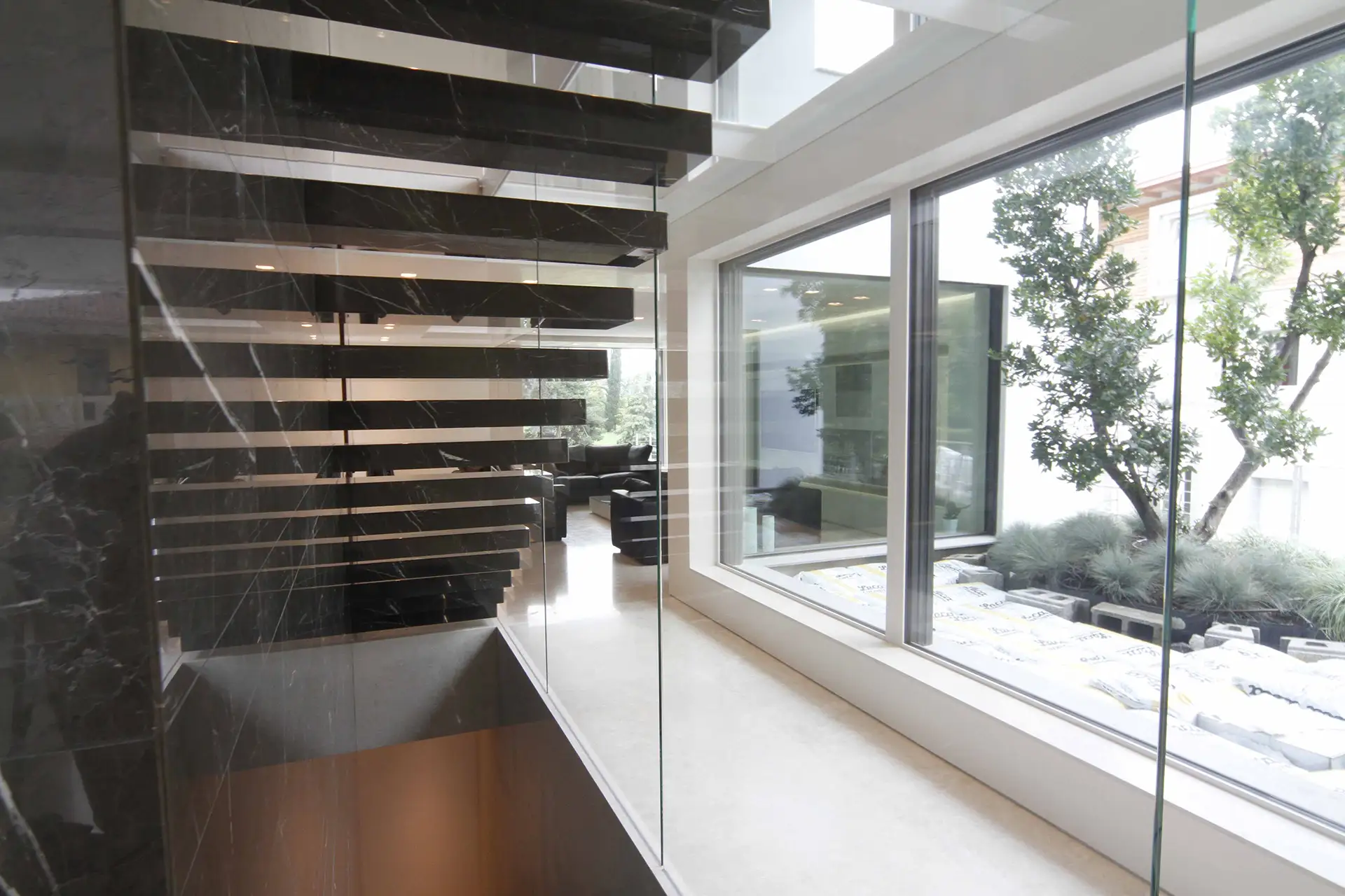 Sculptural interior staircase rising through a double-height space